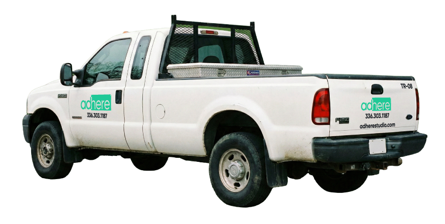 Adhere Studio branding on a white work truck